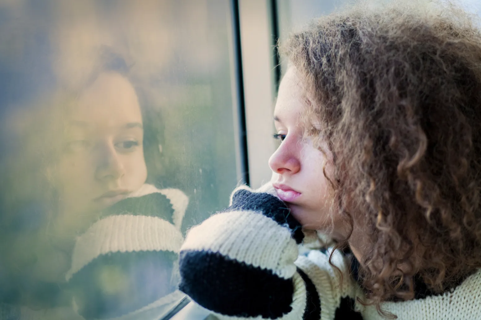 Mp22870052 serious teenage girl sitting by the window