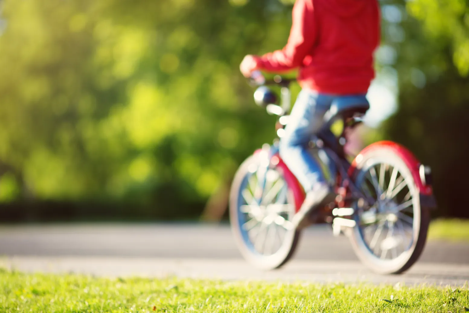 Mp42750340 blurred view to a child on a bicycle at asphalt road