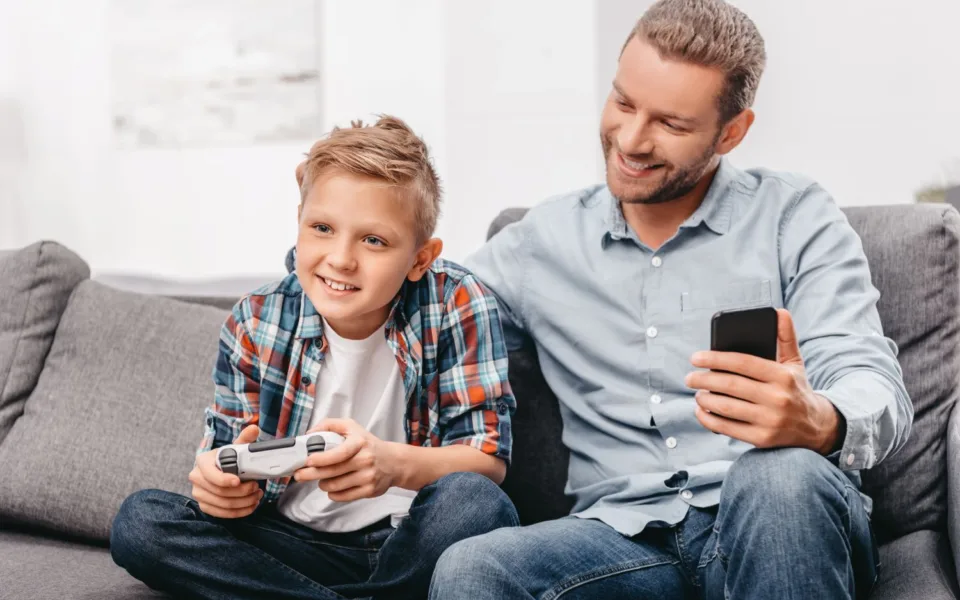 23055744 boy playing videogames with dad 2