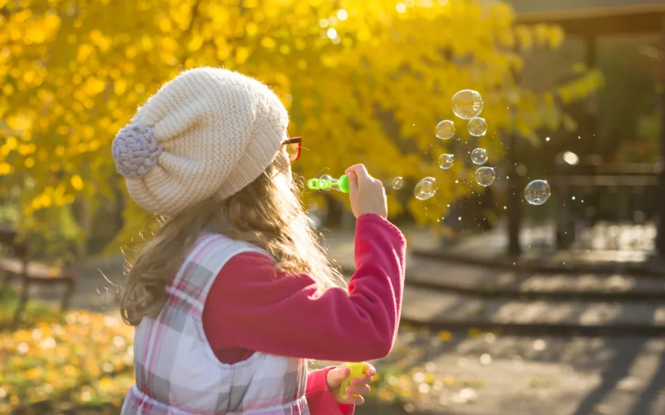 35000224 autumn outdoor portrait of a child girl blowing soap