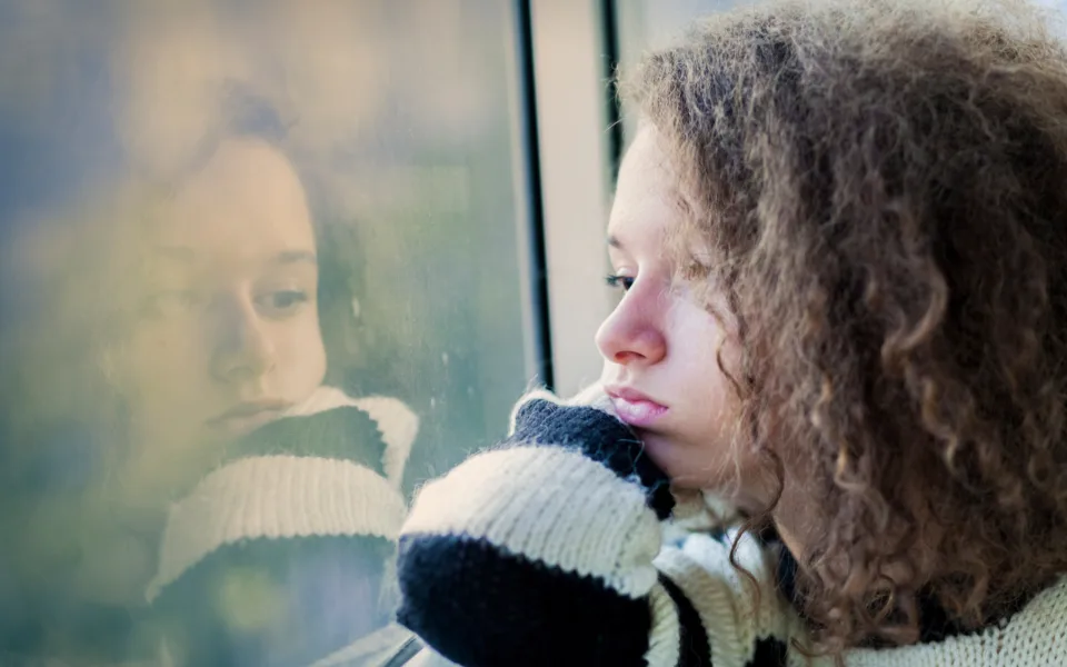 Mp22870052 serious teenage girl sitting by the window