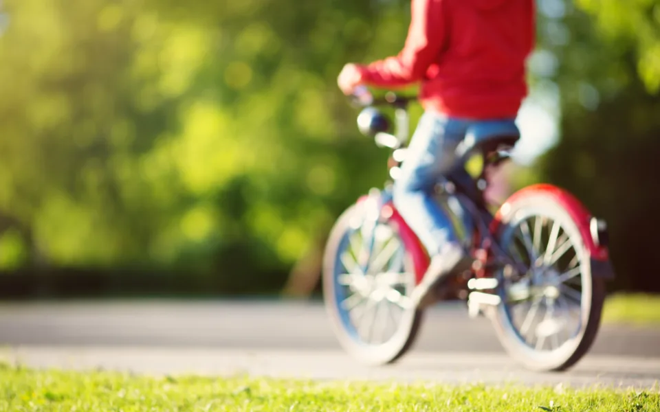 Mp42750340 blurred view to a child on a bicycle at asphalt road